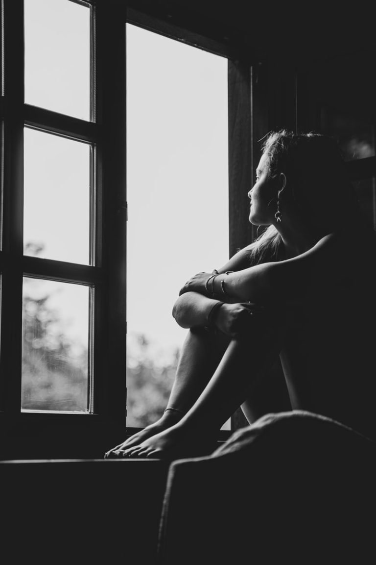 woman sitting on window